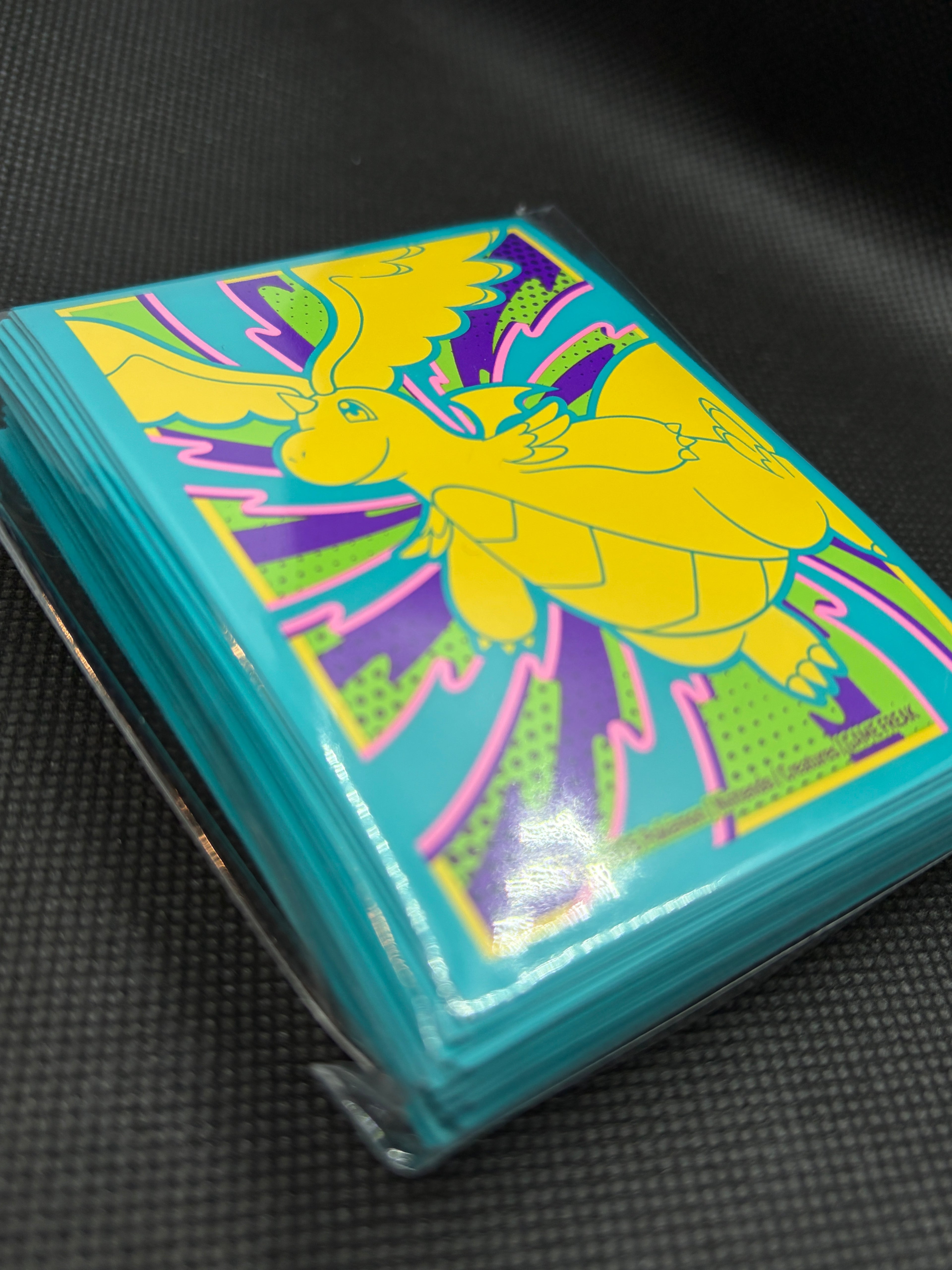 Mega Dragonite Ascended Heroes Premium Card Sleeves. Side view of sealed packet and showing sleeve count of 65. 