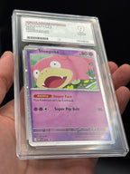 Handheld close-up of English Slowpoke #086 Black Star Promo 2026 Pokémon card in an ACE 9 Mint slab, showing artwork and grading label