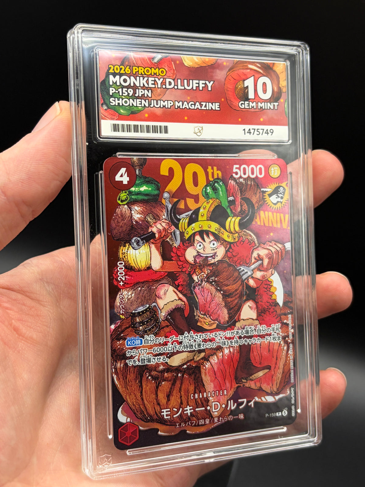 Handheld close-up of Japanese Monkey D. Luffy P-159 One Piece promo in an ACE 10 Gem Mint slab, showing 29th anniversary artwork and grading label